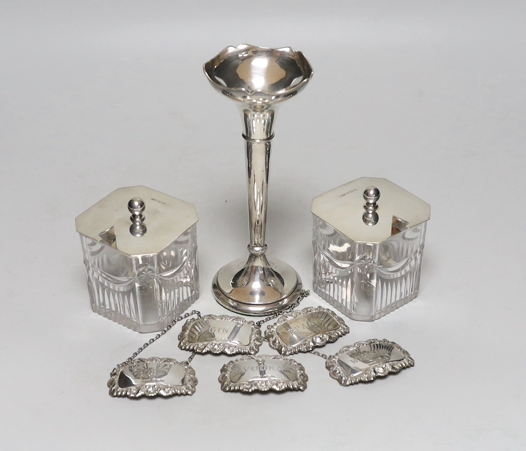 A pair of George V silver mounted cut glass preserve jars, George Unite & Sons, Birmingham, 1915, height 90mm, together with a pair of George IV silver condiment spoons, London, 1823, a silver mounted posy vase and a set